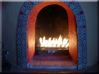 traditional mexican style fireplace with fire glass